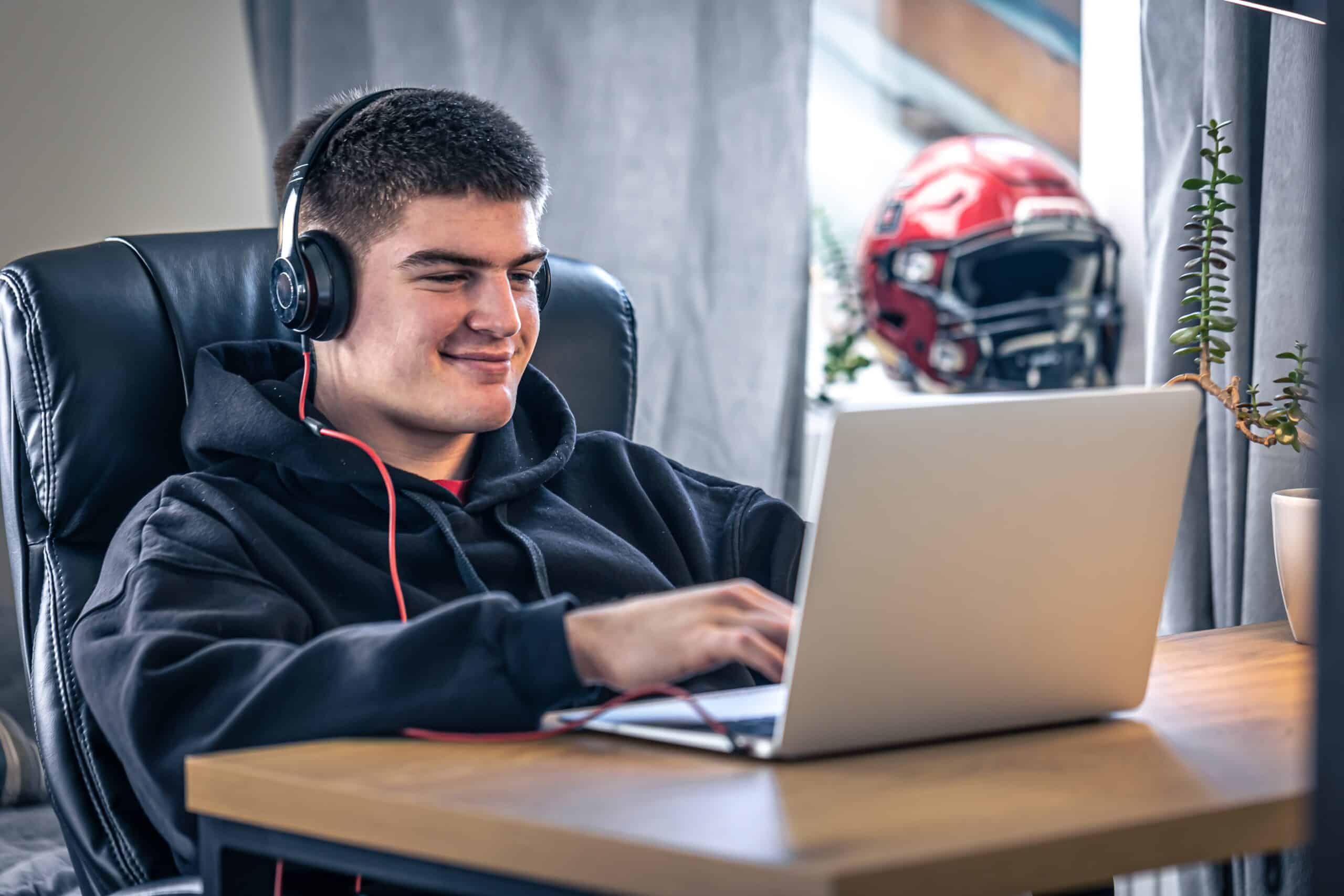 Young Male Athlete Sits and engages in online functional nutrition session.