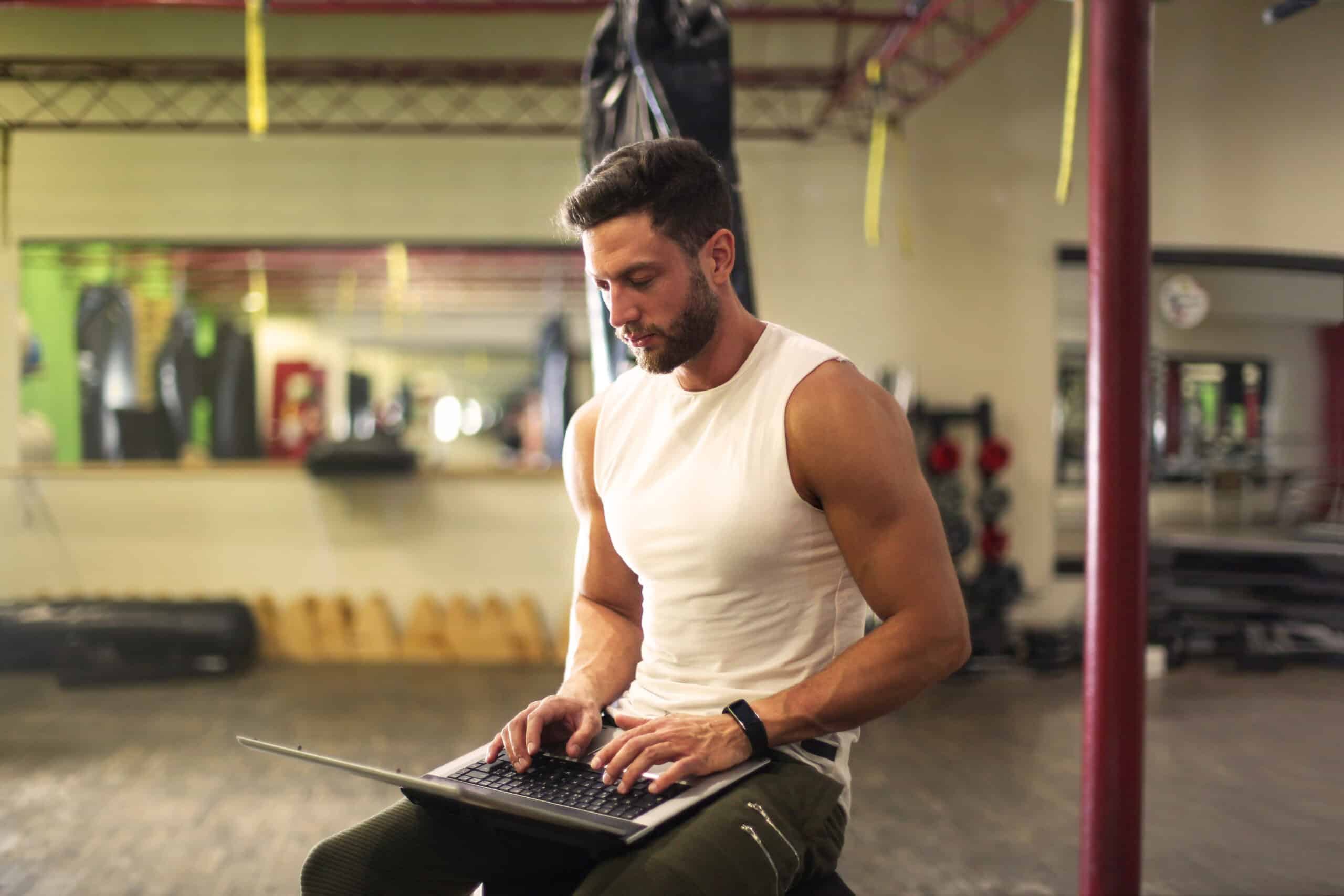 Fit Man Using A Laptop to consult with Epic Biology nutrition